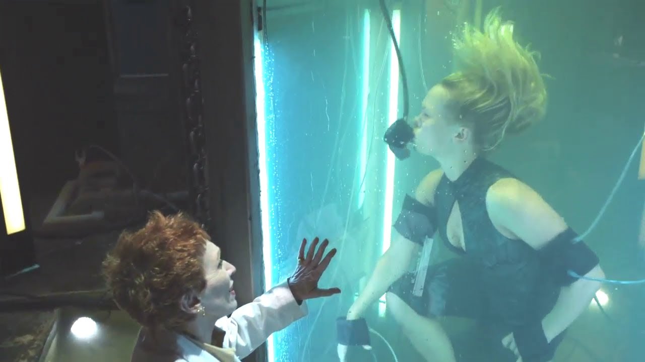woman underwater in tank